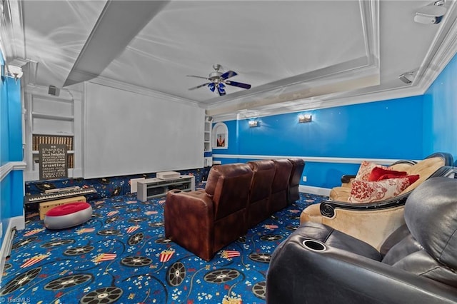 carpeted home theater room featuring crown molding and a ceiling fan