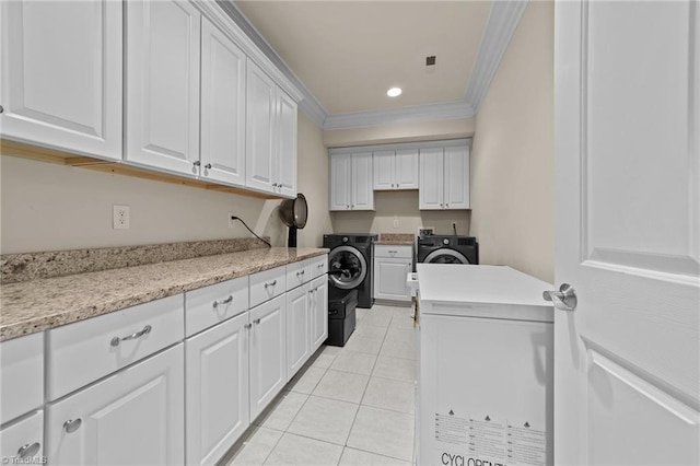 clothes washing area featuring cabinet space, ornamental molding, washer and dryer, light tile patterned flooring, and recessed lighting
