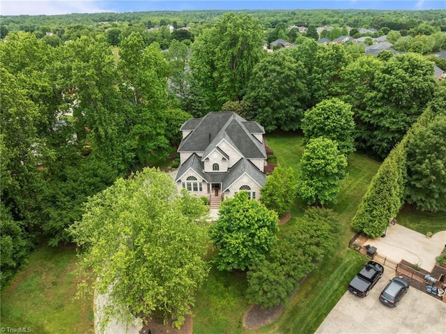 view of subject property featuring a heavily wooded area