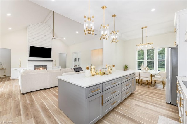 138 Arthur Needham Rd, Pilot Mountain, NC 27041 - kitchen featuring gray cabinets, freestanding refrigerator, a chandelier, light wood-style flooring, and a kitchen island