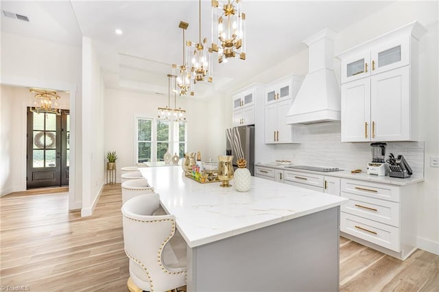 138 Arthur Needham Rd, Pilot Mountain, NC 27041 - kitchen with a chandelier, stainless steel fridge with ice dispenser, black electric cooktop, custom exhaust hood, and light wood-type flooring