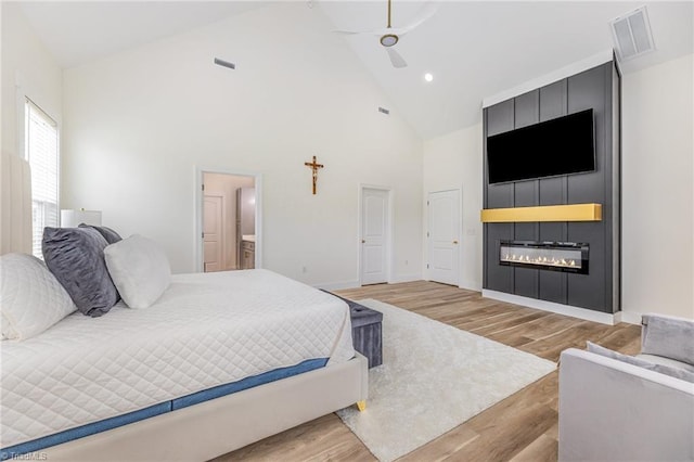 138 Arthur Needham Rd, Pilot Mountain, NC 27041 - bedroom with a fireplace, high vaulted ceiling, light wood-type flooring, baseboards, and ensuite bath