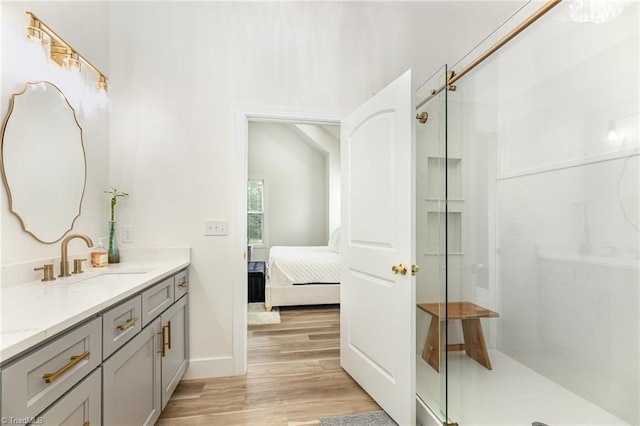 138 Arthur Needham Rd, Pilot Mountain, NC 27041 - full bathroom with a stall shower, double vanity, wood finished floors, ensuite bath, and baseboards
