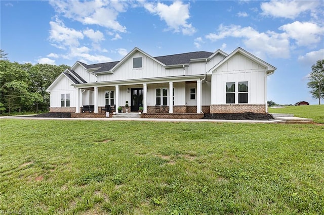 138 Arthur Needham Rd, Pilot Mountain, NC 27041 - modern farmhouse featuring board and batten siding, a porch, a front lawn, and roof with shingles