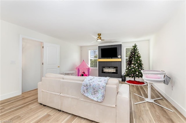 138 Arthur Needham Rd, Pilot Mountain, NC 27041 - living area with a large fireplace, light wood-type flooring, ceiling fan, and baseboards