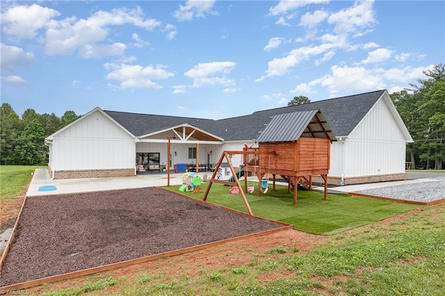 138 Arthur Needham Rd, Pilot Mountain, NC 27041 - view of front of house featuring a playground, a front lawn, a patio, and a shingled roof
