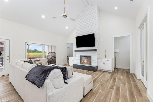 138 Arthur Needham Rd, Pilot Mountain, NC 27041 - living area with a ceiling fan, high vaulted ceiling, a large fireplace, light wood finished floors, and baseboards
