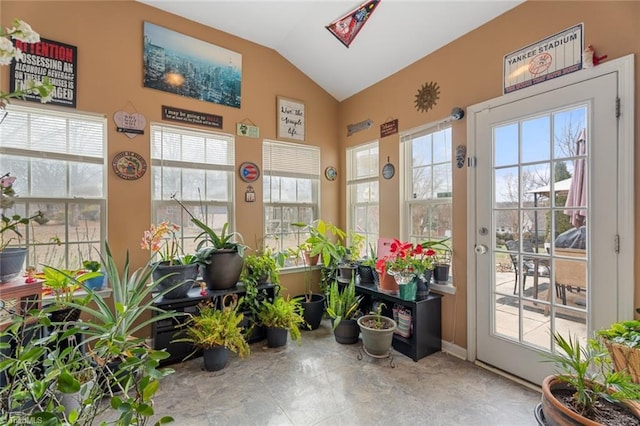 sunroom featuring vaulted ceiling and plenty of natural light