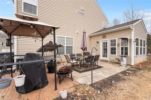 view of patio / terrace with a gazebo and a fire pit