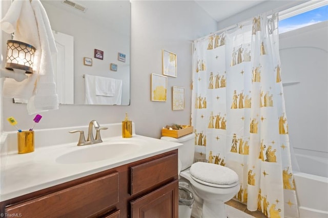 full bathroom with vanity, shower / bath combo, and toilet