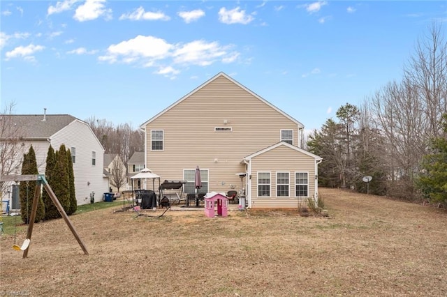 back of property with a playground and a lawn