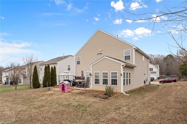 back of house featuring a yard and a patio