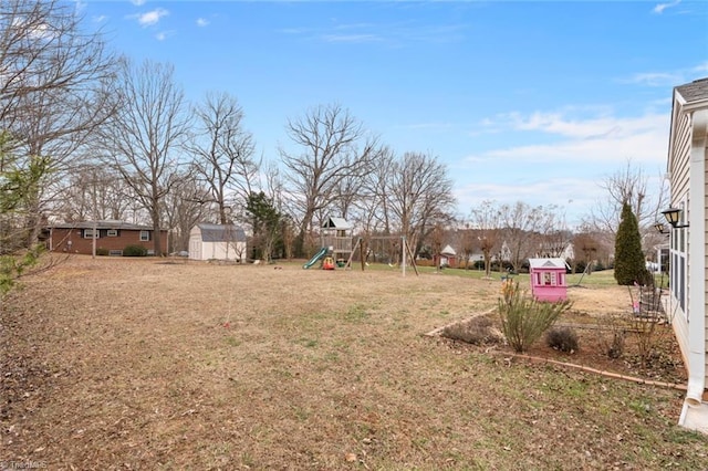 view of yard with a playground and a storage unit