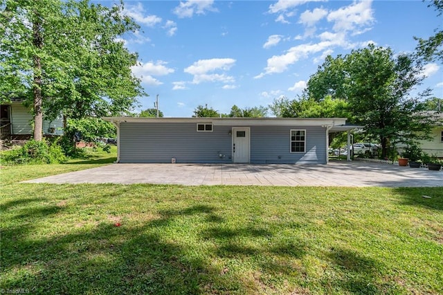 rear view of house with a patio area and a lawn