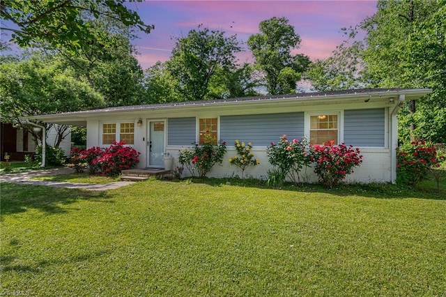 ranch-style home featuring a lawn