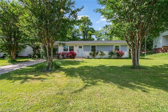 ranch-style house with concrete driveway and a front lawn