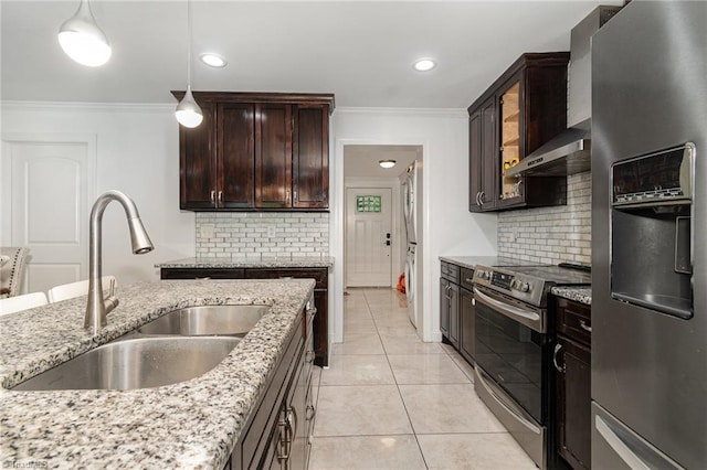 kitchen with a sink, tasteful backsplash, appliances with stainless steel finishes, light stone counters, and ornamental molding