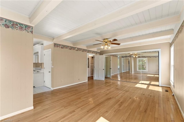 interior space featuring beam ceiling, ceiling fan, and light hardwood / wood-style flooring