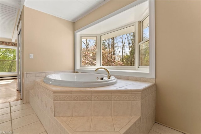 bathroom with tile patterned floors, tiled bath, and crown molding