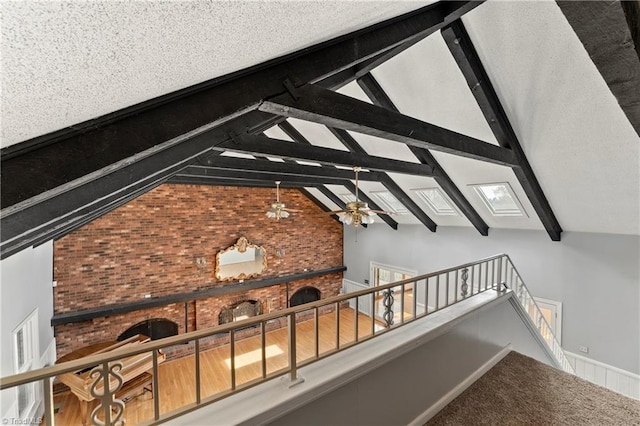 interior details with beam ceiling, a textured ceiling, and ceiling fan