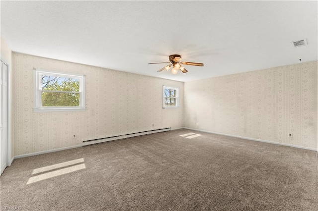 carpeted spare room with baseboard heating and ceiling fan