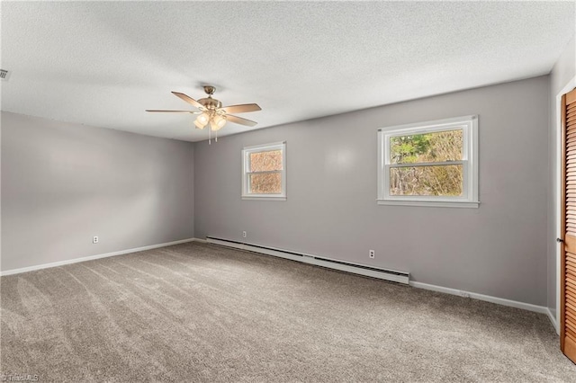 carpeted empty room featuring ceiling fan, a baseboard radiator, and a textured ceiling