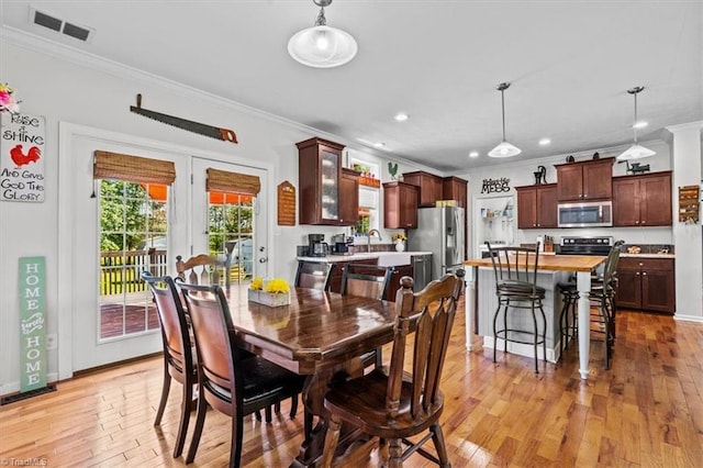 6770 Cotton Rd, Gibsonville, NC 27249 - dining space featuring ornamental molding, light wood-type flooring, and recessed lighting