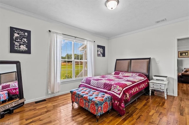 6770 Cotton Rd, Gibsonville, NC 27249 - bedroom with hardwood / wood-style floors, ornamental molding, and a textured ceiling
