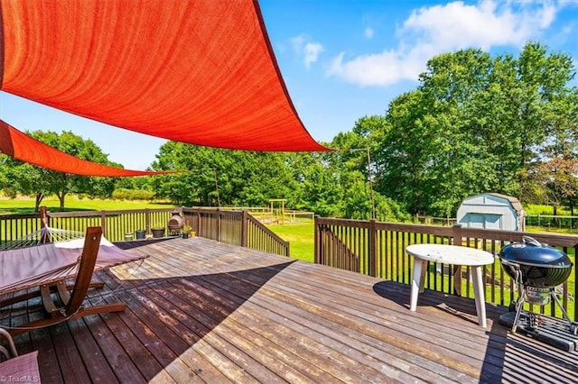 6770 Cotton Rd, Gibsonville, NC 27249 - wooden terrace with a storage unit, a lawn, and view of scattered trees