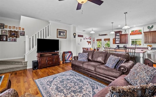 6770 Cotton Rd, Gibsonville, NC 27249 - living area with stairway, crown molding, a ceiling fan, and light wood-style floors