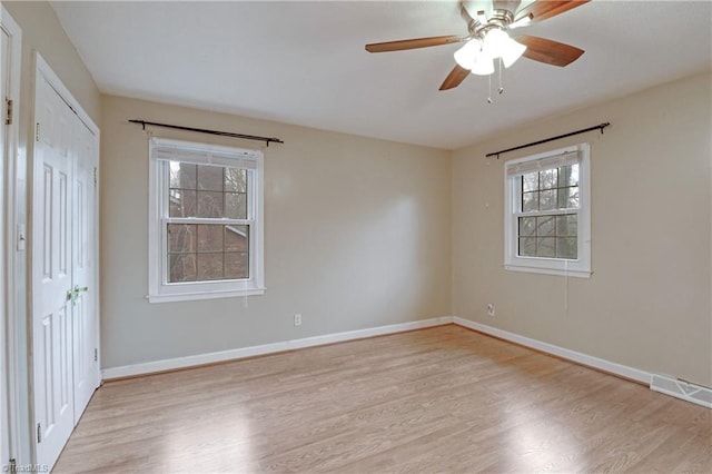 empty room with light hardwood / wood-style floors and ceiling fan