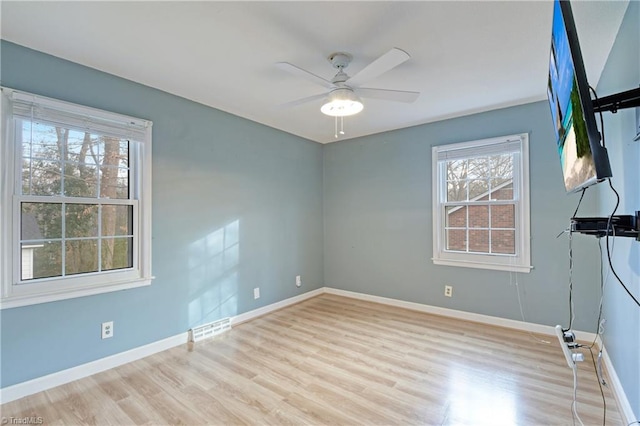 spare room with ceiling fan and light hardwood / wood-style flooring