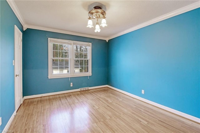 unfurnished room with crown molding and light wood-type flooring