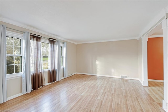 spare room with light wood-type flooring and crown molding