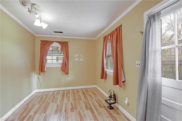 unfurnished room featuring light hardwood / wood-style flooring and ornamental molding