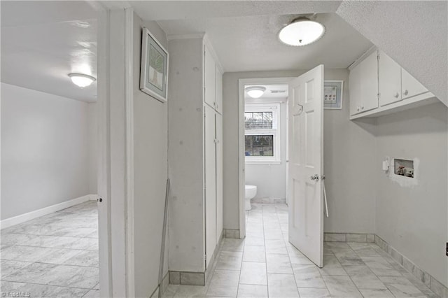 clothes washing area featuring cabinets and washer hookup