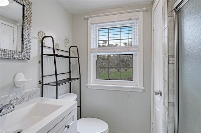 bathroom with vanity, toilet, and walk in shower