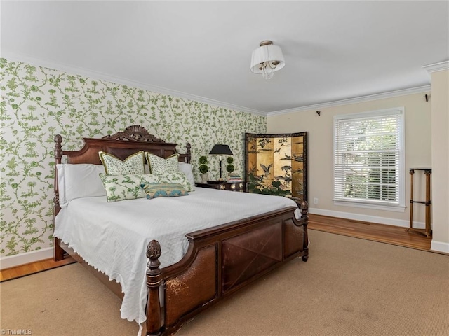 bedroom with wallpapered walls, crown molding, wood finished floors, and baseboards