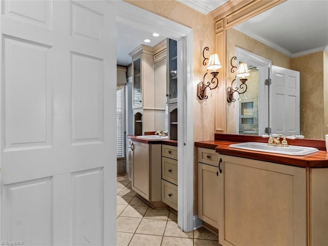 bathroom with tile patterned floors, vanity, and crown molding