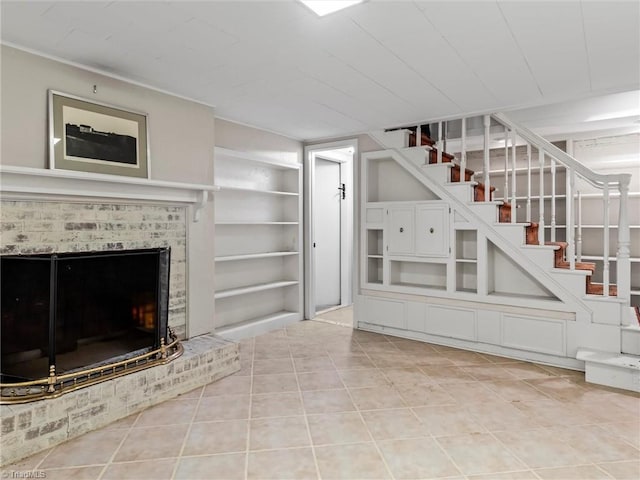 unfurnished living room featuring light tile patterned flooring, built in shelves, a fireplace, and stairs