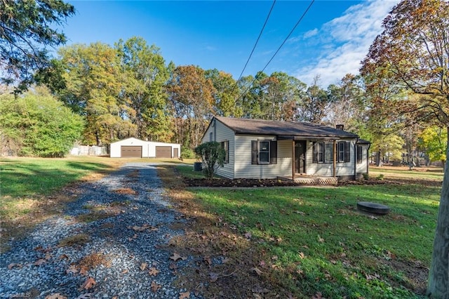 view of front of house with a front lawn, a garage, and an outdoor structure