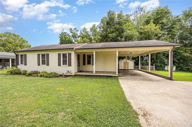208 Maple St, Yadkinville, NC 27055 - view of front facade with a front yard, driveway, covered porch, a shed, and a carport