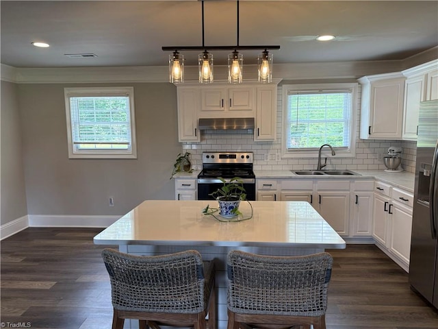 6472 S NC Highway 801 S, Mocksville, NC 27028 - kitchen with stainless steel appliances, wall chimney range hood, healthy amount of natural light, white cabinets, and recessed lighting