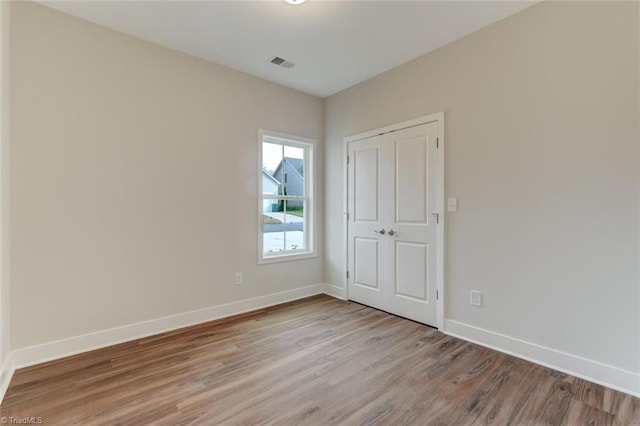 spare room with light hardwood / wood-style flooring