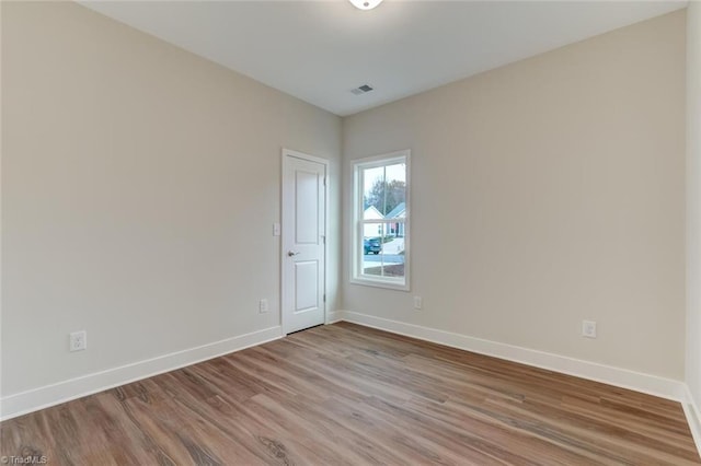 unfurnished room with hardwood / wood-style floors