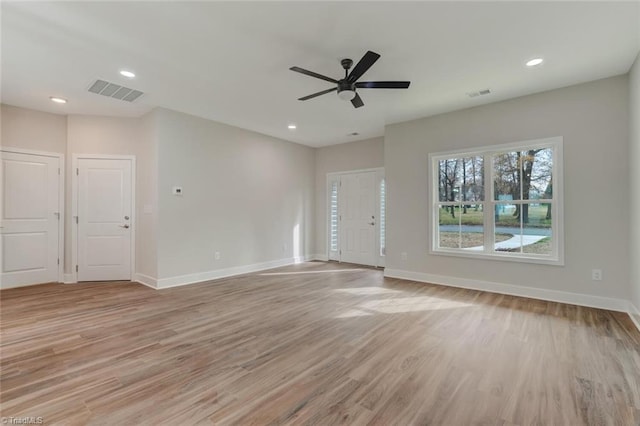 unfurnished living room featuring ceiling fan and light hardwood / wood-style floors