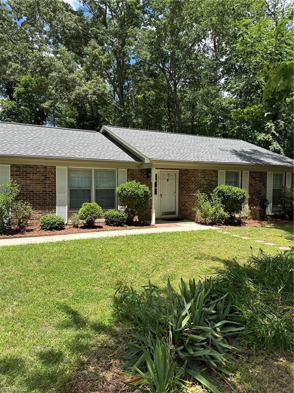 4 Manard Ct, Greensboro, NC 27407 - single story home featuring brick siding, a front yard, and a shingled roof
