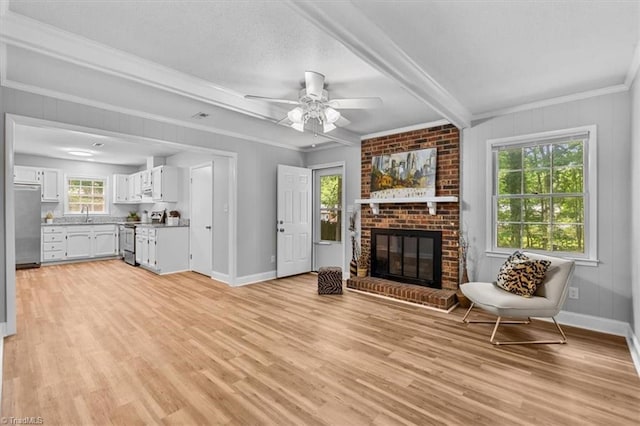 4 Manard Ct, Greensboro, NC 27407 - living room with light wood-style floors, a ceiling fan, a fireplace, beam ceiling, and ornamental molding