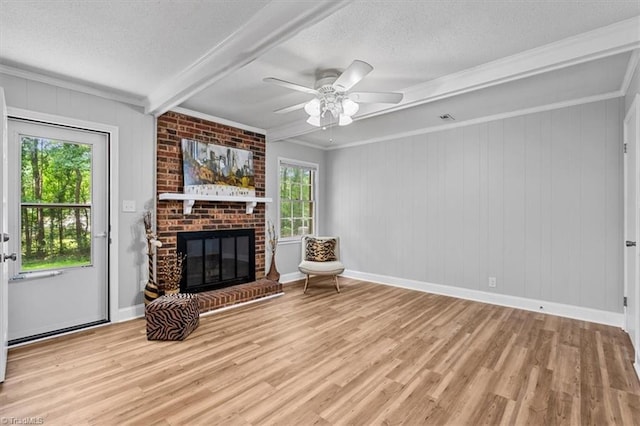 4 Manard Ct, Greensboro, NC 27407 - unfurnished living room with a textured ceiling, beam ceiling, wood finished floors, a fireplace, and ceiling fan