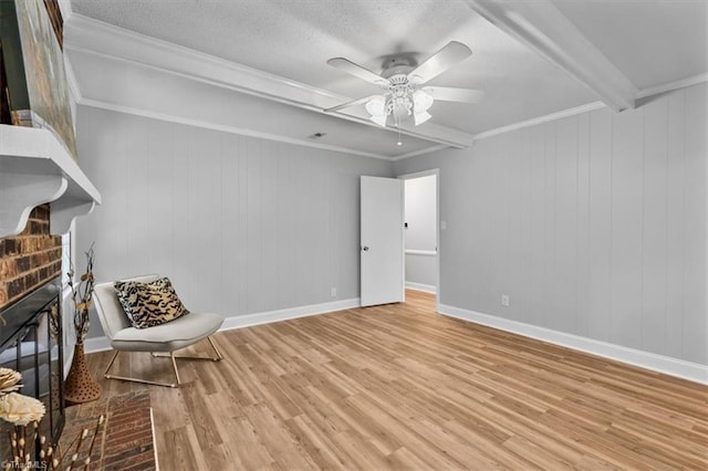 4 Manard Ct, Greensboro, NC 27407 - unfurnished living room featuring wood finished floors, a fireplace, a ceiling fan, beamed ceiling, and baseboards